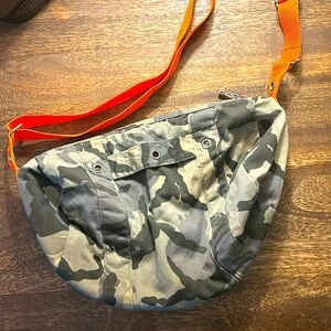 Grey camouflage mini duffle bag with orange adjustable strap